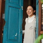 Woman smiling in door frame