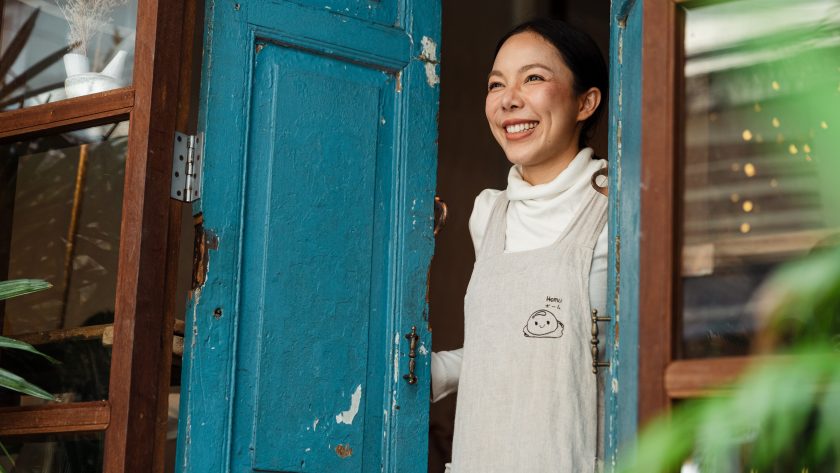 Woman smiling in door frame