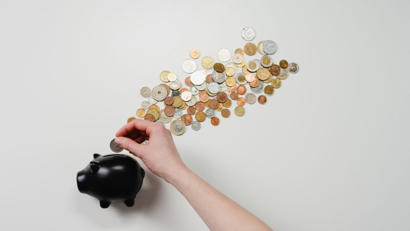 Coins falling out of a piggy bank