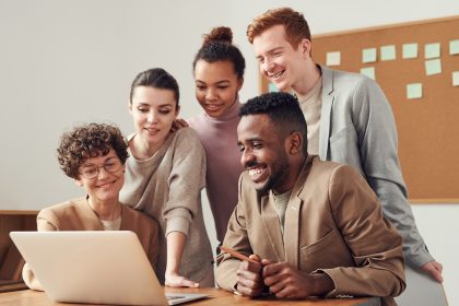 People Smiling Over a Desk
