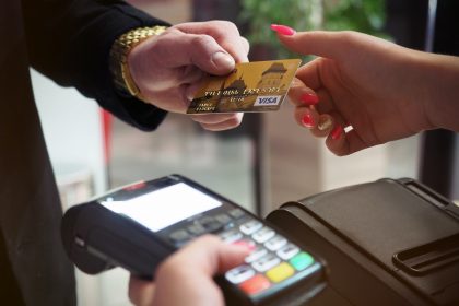 a man handing a woman a credit card