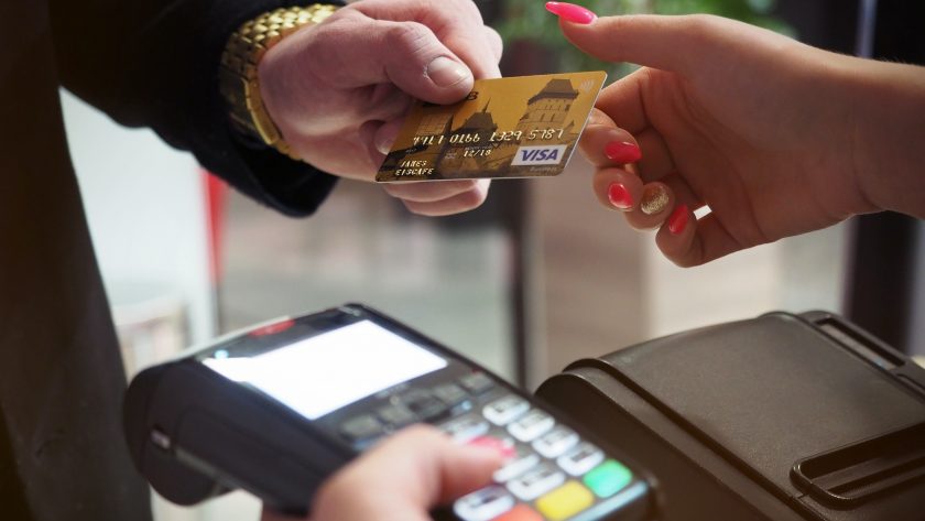 a man handing a woman a credit card