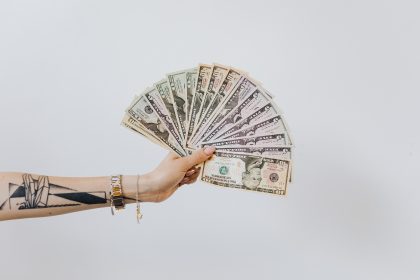 woman holding a money fan