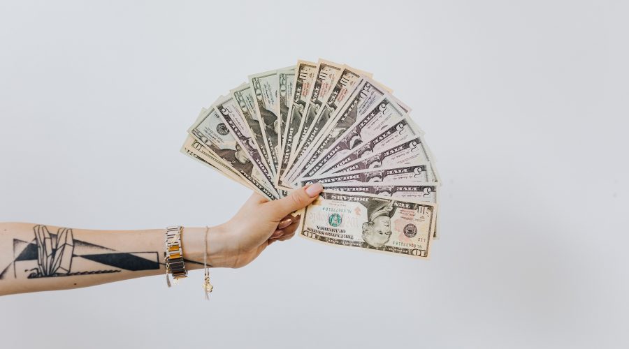 woman holding a money fan